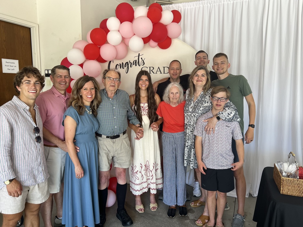 Jon with family at a graduation celebration